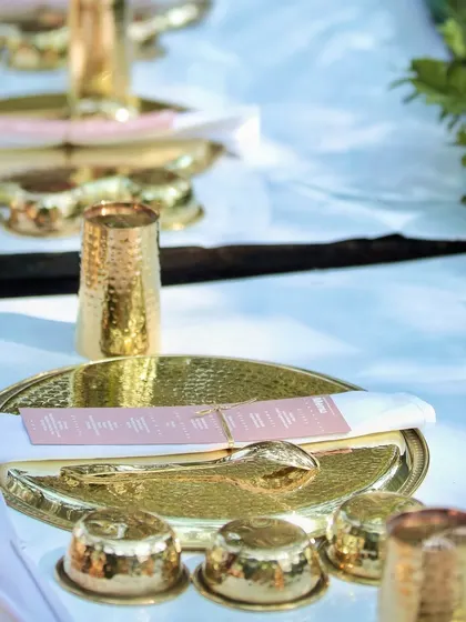 The place setting for my modern Pangat, featuring beautiful golden thalis and bowls, ready for the feast to be served.