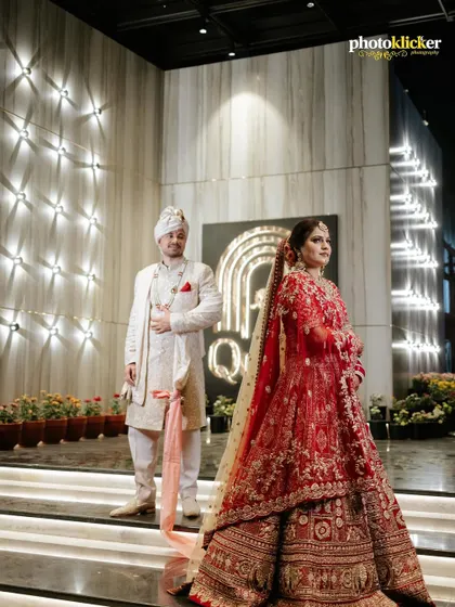 A wide shot of the couple at their wedding venue, showcasing the modern decor and creating a sense of grandeur. (Note: These are duplicate images).
