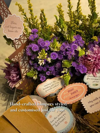 A Paris-themed hamper designed for a true romantic. It features a stunning floral arrangement, an Eiffel Tower cutout, and personalized tags with sweet messages, showing how I can bring any theme to life.