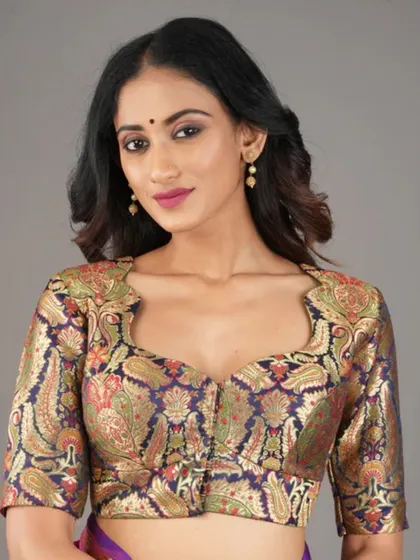 A close-up of our brocade blouse with a paisley pattern and a sweetheart neckline. The rich colors and texture are perfect for festive wear.
