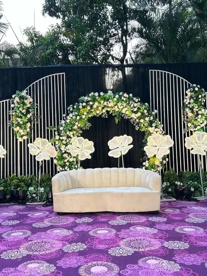 Another angle of the Indian stage decor, showcasing the balance of floral elements and modern lighting. The design creates a beautiful frame for the main seating area.