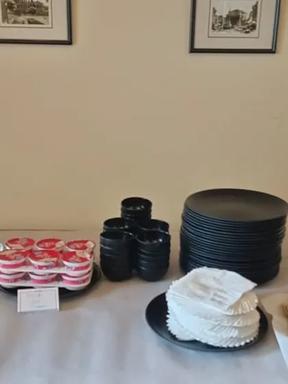 Another look at the simple yet elegant dessert station, complete with plates, glasses, and drinks for guests.