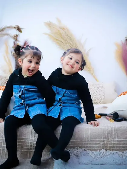 Capturing the different personalities of these adorable twins as they sit together in our studio.