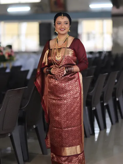 This bride looks serene and beautiful. Her makeup is natural and enhances her features, perfect for the solemnity of the wedding ceremony.