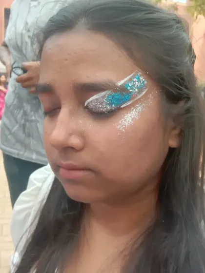 A bold swipe of blue, white, and silver glitter across the eye. This is a fast and high-impact look perfect for parties and festivals.