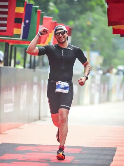 Crossing the finish line at an Ironman event. An unforgettable moment of triumph after months of relentless training.