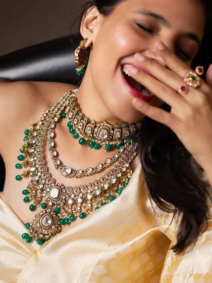 A candid, laughing shot that brings a sense of joy and realism to a bridal jewellery campaign, showing that traditional looks can also be fun.