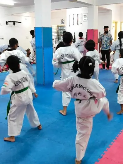 A view from the back of students practicing their kicks.