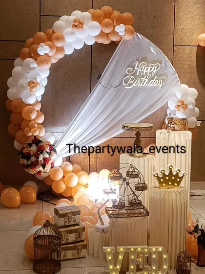 An orange and white balloon ring with a sheer curtain, creating a warm and inviting look.