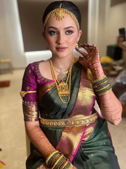 Getting this bride ready for her big day. This look features a clean, traditional hairstyle with a matha patti and soft, glowing makeup to enhance her natural features.