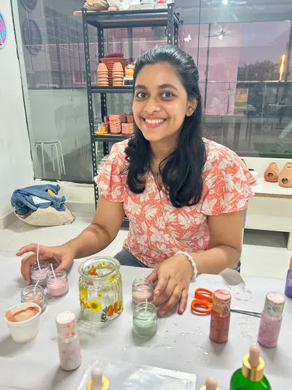 This guest is working on her pressed flower candle holders, a popular choice for its delicate and natural aesthetic.