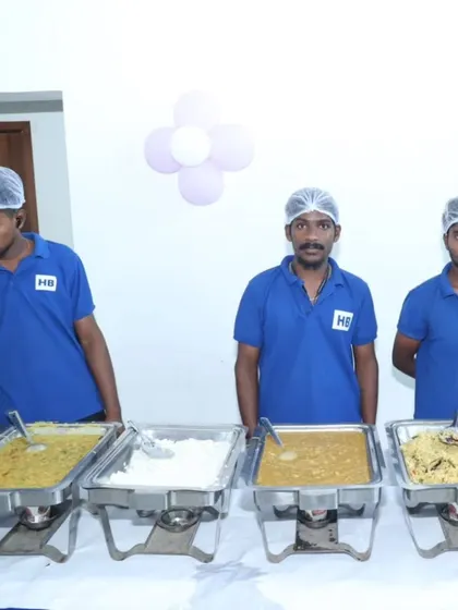 Three of our team members in uniform, ensuring the buffet is always ready for service at an event.