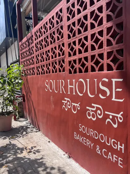 Typographic wall art is a crucial part of branding. For this sourdough bakery, I hand-painted their logo and name in English and Kannada, giving the entrance an organic, artisanal look.