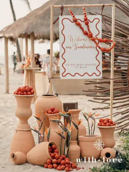 The welcome installation for the sundowner, with terracotta pots and a fun sign that reads "iOS has been updated to WeOS".