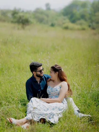 A candid moment of laughter and connection during a pre-wedding shoot in a sun-drenched field. My goal is to make you feel comfortable, so your real personalities shine through.