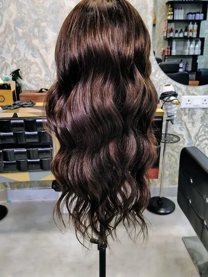 The lighting makes a difference, but the beauty of the wig is constant. This piece, with its rich color and soft waves, can be customized in any shade.