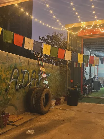The vibe at our club in the evening. The string lights and prayer flags create a unique and welcoming atmosphere for our late night training sessions.
