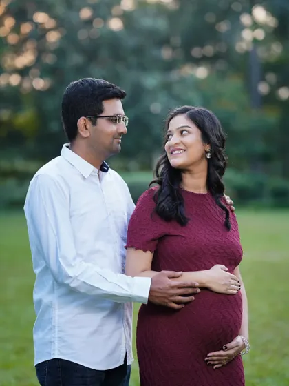 A candid and sweet moment between a couple during their outdoor maternity shoot. The genuine smiles and interaction are what make these sessions so special.