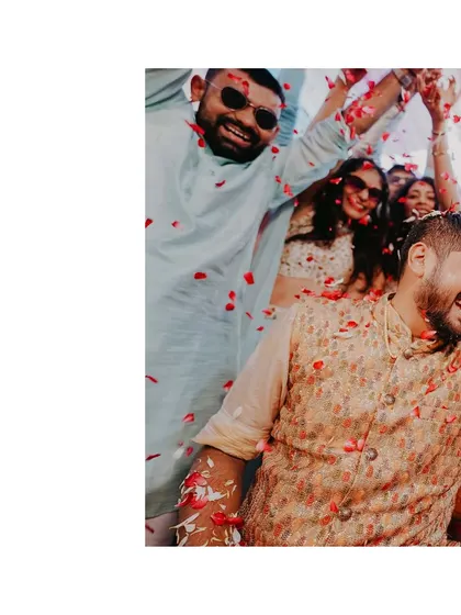 A candid shot of the groom and guests laughing as they are showered with flower petals. It's these unscripted moments of joy that make the best memories.