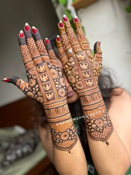 A gorgeous non-figurative bridal design, focusing on intricate patterns, floral motifs, and rows of elephants for a traditional yet clean look.