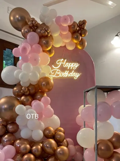 A stylish pink, rose gold, and white balloon arrangement on an arch backdrop. This versatile design is perfect for birthdays, bridal showers, or any chic celebration.