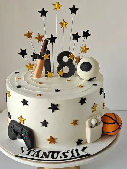 An 18th birthday cake for a young man who loves sports, gaming, and music. I included his favorite things like a cricket bat, football, basketball, and AirPods, all handcrafted from fondant.