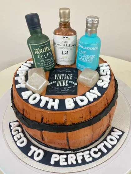 "Aged to Perfection." This whisky barrel cake is perfect for a connoisseur's milestone birthday, complete with edible ice cubes and miniature fondant bottles of their favorite brands.