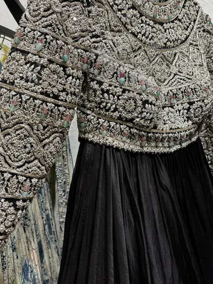 A stunning black Anarkali with a heavily embroidered jacket, spotted at Pernia's Pop-Up Shop. A perfect example of the kind of unique, high-fashion pieces you can find there.