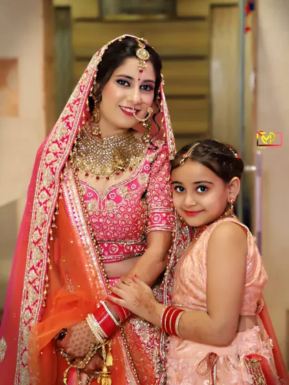 A heartwarming photo of the bride with a young family member. These are the precious, candid moments that add so much warmth to a wedding album.