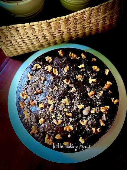 A top-down view of my dark chocolate, walnut, and date cake. It's made with whole wheat flour, sweetened with jaggery, and is completely eggless. A truly yummity treat.