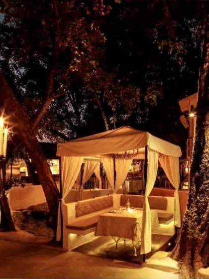 The restaurant at night, with candelabras lighting the way. The ambiance is designed to be enchanting and transportive, making you feel like you are in Spain.