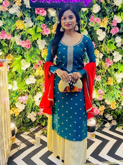 Standing tall and stylish. This printed clutch is the perfect accessory for a festive gathering, adding a unique touch to a traditional outfit.