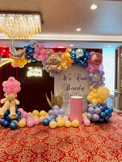 An alternate wide shot of the baby shower setup, showing the beautiful blend of pastel and metallic balloons that create a dreamy and celebratory feel.