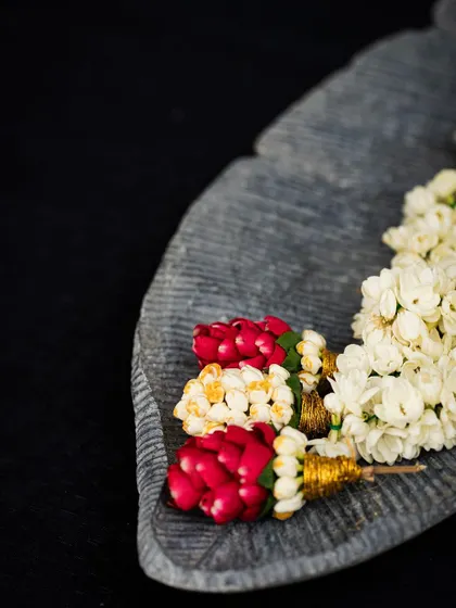 A close-up of a traditional jasmine garland from our styling workshop. The intricate weaving and delicate fragrance of these garlands are a hallmark of South Indian celebrations.