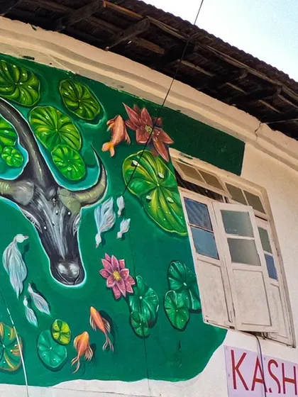 The upper portion of the Fort Kochi mural, showing a buffalo and fish in a pond. This part of the mural represents the rich ecosystem and the daily life that revolves around the water in this coastal town.