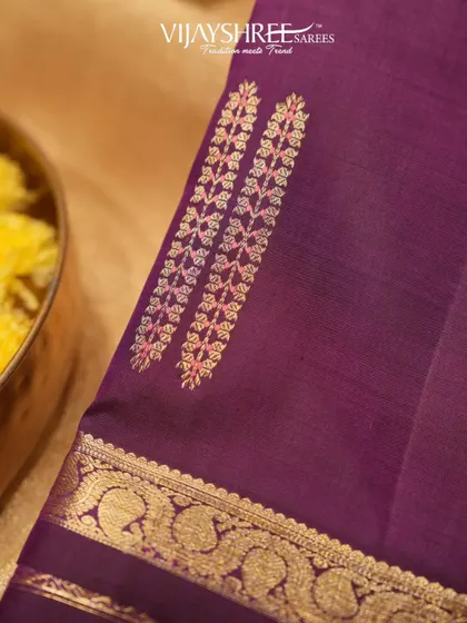 A close-up of the unique butta design on the purple Kanjivaram.