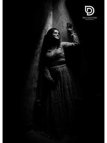 A dramatic black and white bridal portrait using a single sliver of light. This low-key photography technique creates a moody, artistic, and timeless image.