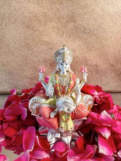 A solo view of the exquisite hand-painted Goddess Lakshmi idol, capturing her serene expression and the pot of wealth she holds.