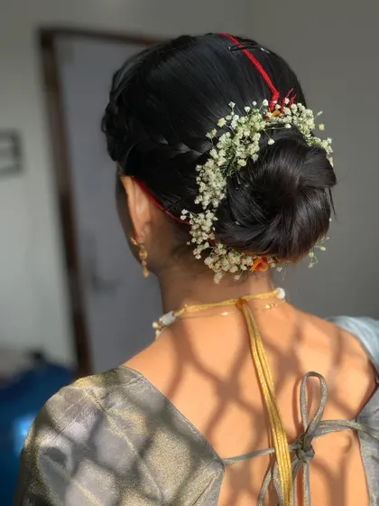 A close up of the elegant floral bun created for Manisha's Path function.