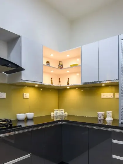 A detail shot of the corner, showing the illuminated open shelving that is perfect for displaying decorative items or frequently used spices.