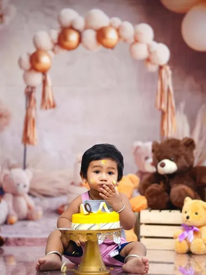 Perfect for a first birthday, our 'Teddy Bear Picnic' theme includes a cake smash moment. Here, the birthday boy enjoys his cake surrounded by his furry friends.