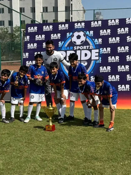 The complete Under 10 squad with their coach and the SAR Pride Cup trophy. A proud moment for everyone involved.