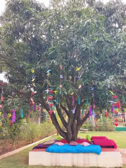 A wide shot of the vibrant Mehendi seating area, showing the mix of bright, eclectic cushions and decor that create a festive atmosphere.