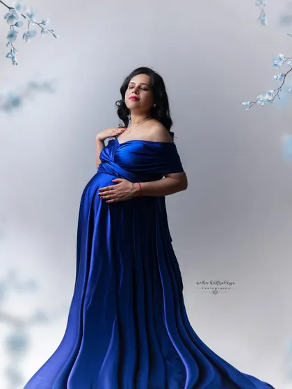Capturing the gentle embrace of the baby bump. This pose is a classic for a reason, it shows the deep connection between mother and child.