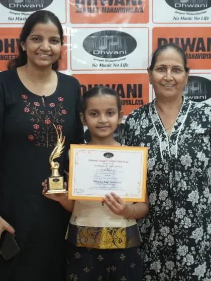 A student with her mother and grandmother, a three-generation celebration.