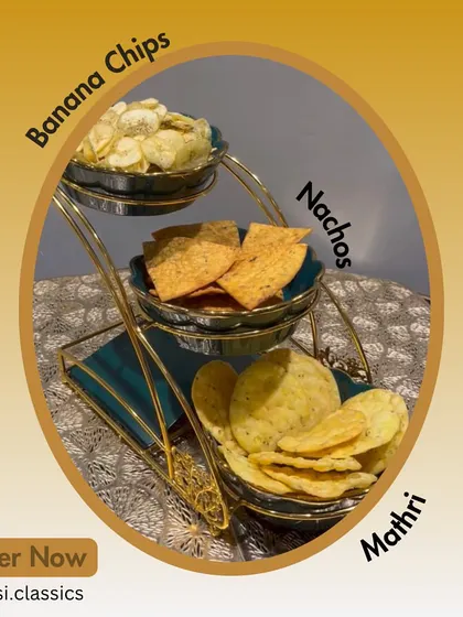 Create your own perfect snack platter with our dry munchies. This beautiful stand features our paper-thin Banana Chips, savory Moong Dal Nachos, and classic flaky Mathri. Order them individually or together for your next get-together.
