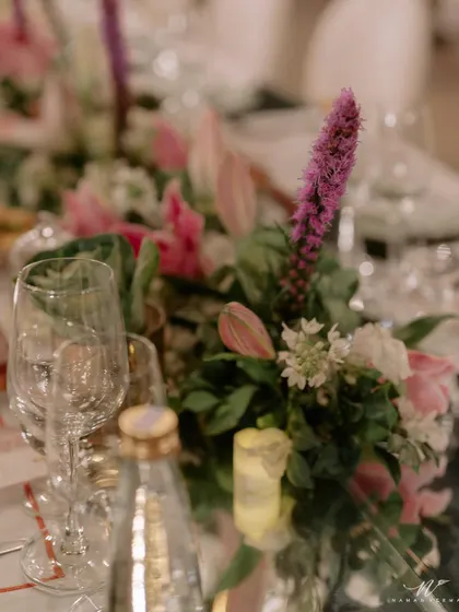 The finale dinner for K+G was planned to perfection. This long table setting features mirrored surfaces reflecting hanging floral arrangements and chandeliers, creating an immersive and glamorous dining experience.