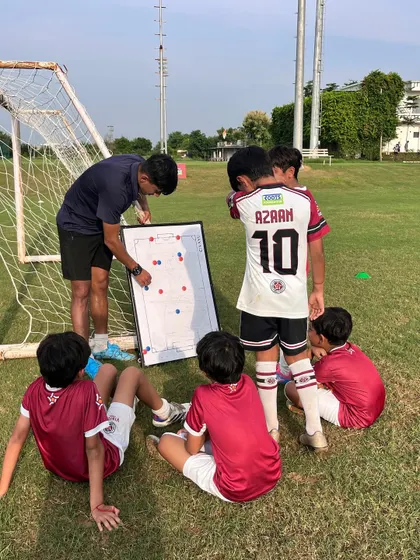 It's not just about drills, it's about strategy. Here, one of our AIFF certified coaches uses a tactical board to teach our U-10 players how to read the game, understand positioning, and make smarter decisions on the field.