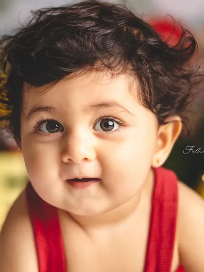 A close-up of a sweet baby boy in his Winnie the Pooh outfit. The soft bokeh background adds a touch of magic to the portrait.