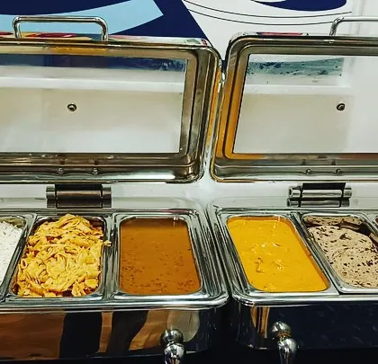 My multi-section chafing dishes allow me to serve a complete meal in one unit. Here you can see rice, a dry vegetable dish, dal, a paneer gravy, and more.